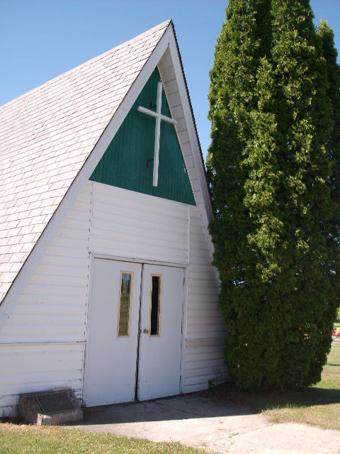building with a cross in front of it