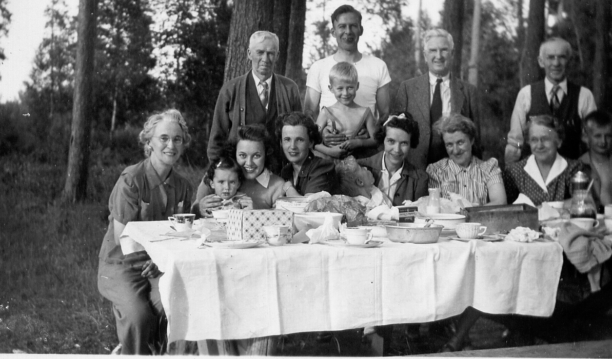 black and white photo of a group of people behind a table