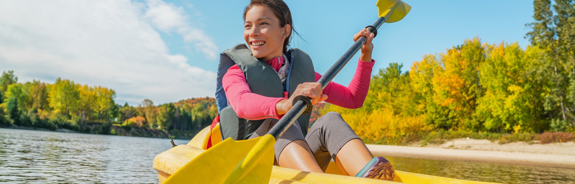 woman kayaking and smiling