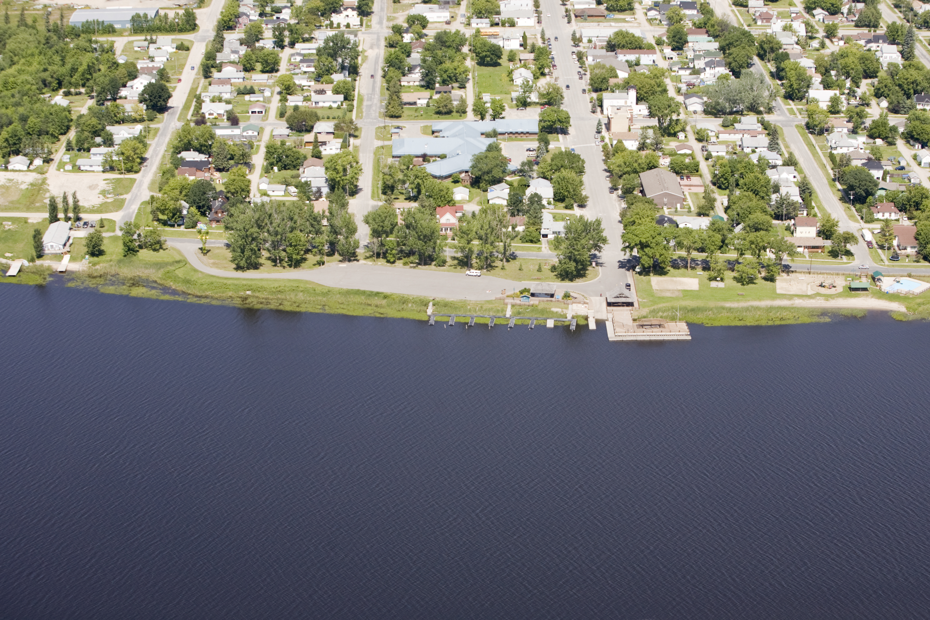 <div class="text-large">aerial view of houses and half of the picture is a body of water</div>