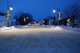 <div class="text-large">a street with streetlights covered in a thin layer of snow</div>