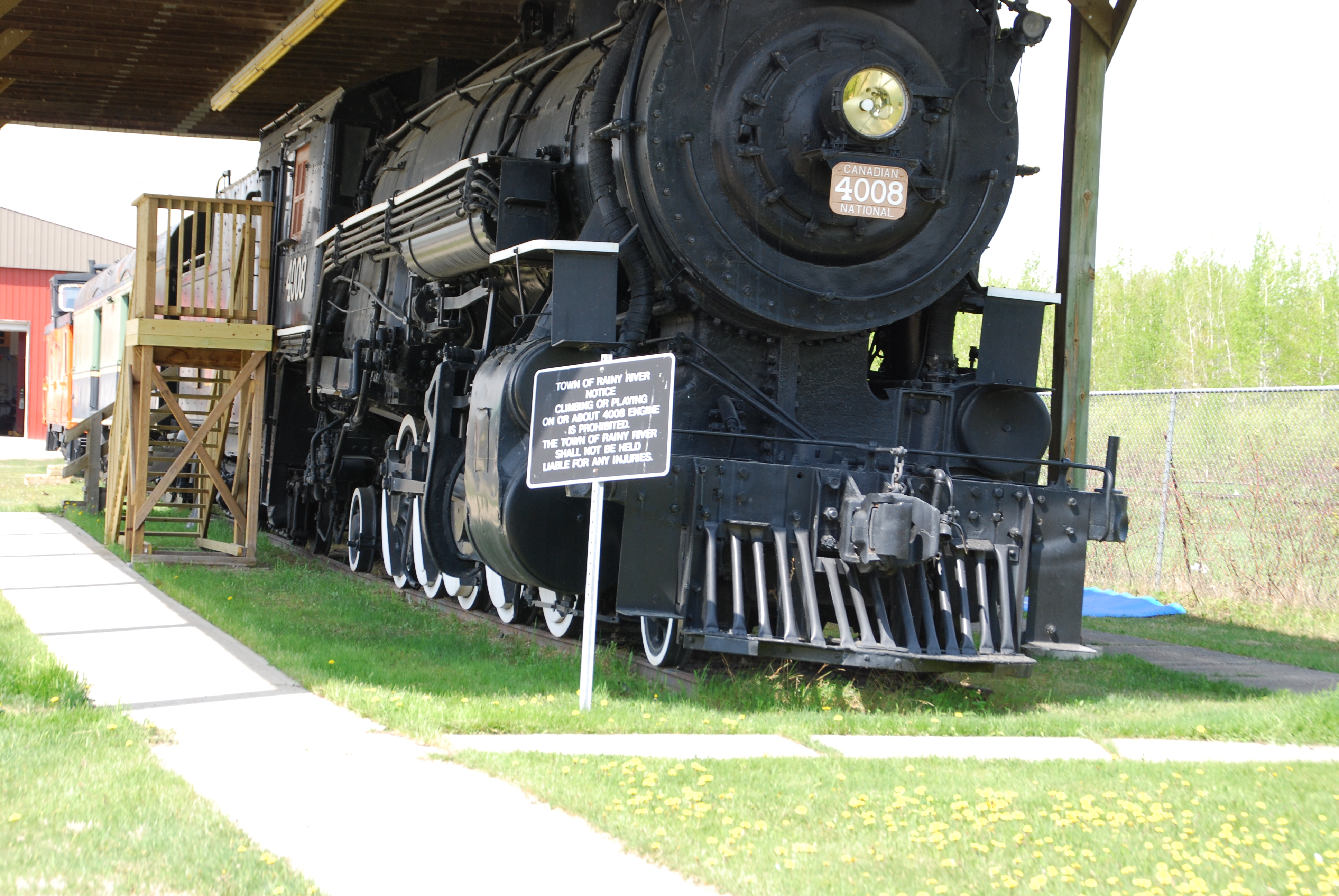 <div class="text-large">a train under a shed with a small walkway beside it</div>