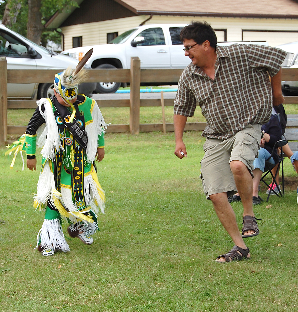 <div class="text-large">a kid in a costume and an adult dancing</div>