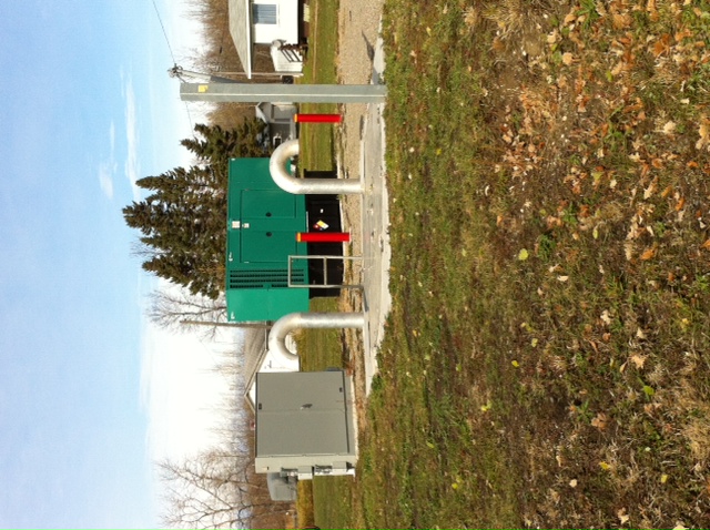 2 metal boxes and 2 cane shaped pipes in a park