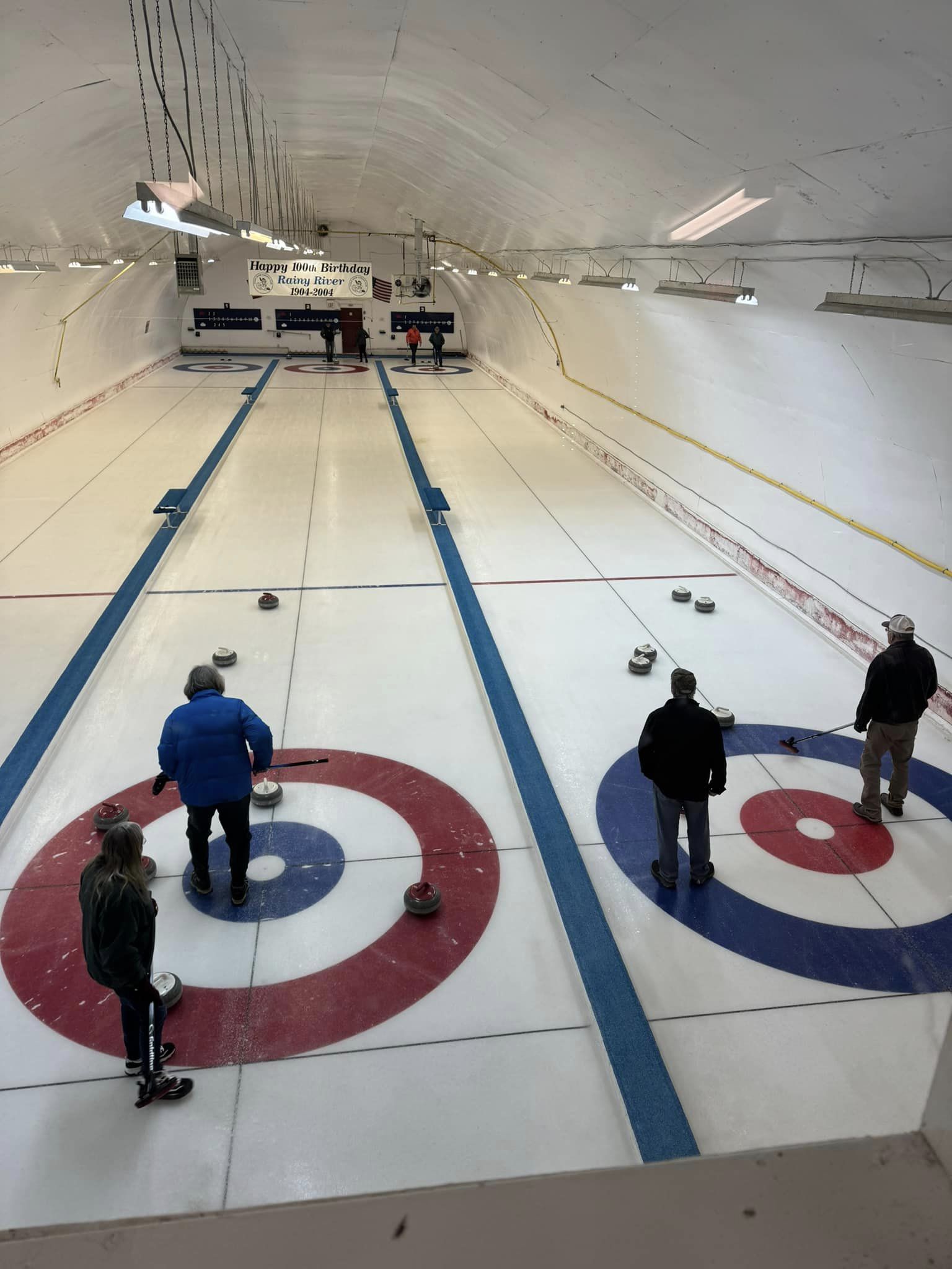 2 lanes in the curling rink with people playing