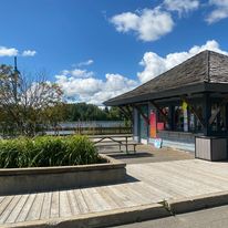 a wooden boardwalk with a covered gazeebo