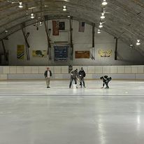 4 guys on the ice surface inspecting the ice