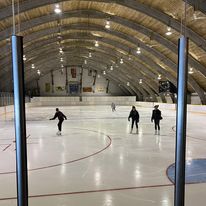 three people inside the ice surface