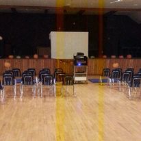 empty auditorium with a stage and chairs