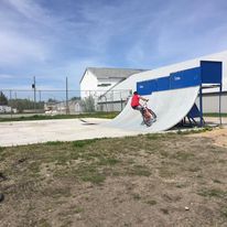 skate ramp with a guy on a bike doing a trick