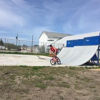 skate ramp with a guy doing a trick on a bike