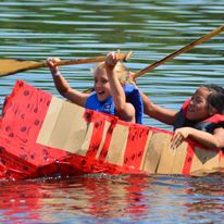 2 girls on a boat with oars