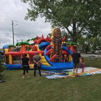 giant inflatable playhouse with 3 grown men standing in front of it