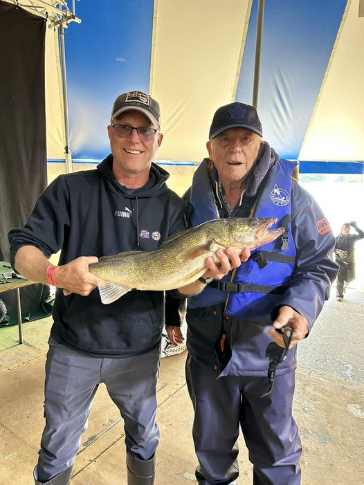 2 guys holding up a walleye salmon